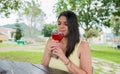 Colombian woman drinking a red cocktail outdoors. Royalty Free Stock Photo