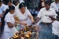 People light candles at the Buddhist temple during Vesak religious celebration in Colombo, Sri Lanka. Royalty Free Stock Photo