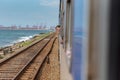 Men in the windows of train from the Interior of the second category train car in Sri Lanka