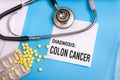 Colon cancer words written on medical blue folder