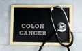 COLON CANCER wrote on chalkboard with stethoscope