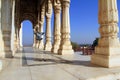 Colonade of white marble columns with flying pigeon