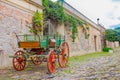 COLONIA DEL SACRAMENTO, URUGUAY - MAY 04, 2016: ancient cart parked in the street next to an old house entrance