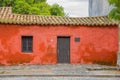 COLONIA DEL SACRAMENTO, URUGUAY - MAY 04, 2016: small little red house with a sign next to the door saying the year when