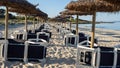 Colonia Sant Jordi, Mallorca, Spain. Beach with straw umbrellas and sunbeds in the morning without people