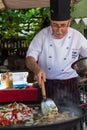COLONIA, URUGUAY - APRIL 19, 2015: Traditional Chef cooking squi