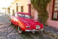 Red automobile on one of the cobblestone streets, in the city of Colonia del Sacramento, Uruguay. It is one of the oldest cities Royalty Free Stock Photo