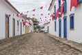 A colonial architecture street in Paraty, adorned with flags for the traditional Divine Holy Spirit Festivity. Brazil. Royalty Free Stock Photo