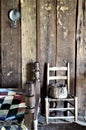 Colonial bedroom with quilt, wall candle tin, chair, and basket