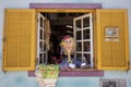 Colonial Brazilian house with decorations and objects. Brazilian decorative woman. Colorful Namoradeira figurine at window as Royalty Free Stock Photo