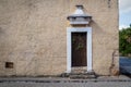 Colonial building with grown ivy on abandoned door, Valladolid, Yucatan, Mexico