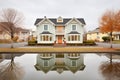 colonial homes reflection in pond with window symmetry