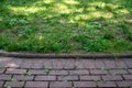 Colonial red brick walkway and green grass background Royalty Free Stock Photo