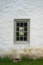 Colonial stone house with blue twelve-pane window exterior