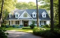 Colonial style family house exterior with black roof tiles. Beautiful landscaped front yard with pebble walkways and trimmed lawn Royalty Free Stock Photo