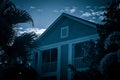 A Colonial Style House Amidst Palm Trees in Blue Royalty Free Stock Photo