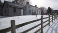 Colonial-style house exterior with wooden  post and rail fence in winter Royalty Free Stock Photo