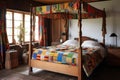 a colonial-style wooden four-poster bed with a patchwork quilt and vintage bedside table