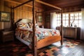 a colonial-style wooden four-poster bed with a patchwork quilt and vintage bedside table