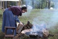 Colonial woman tends fire