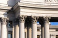 Colonnade with corinthian columns. Detailed view of the top part of column called small capital. Pillars of government. Royalty Free Stock Photo