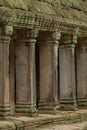 Colonnade of stone pillars under mossy roof