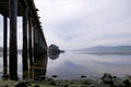 Colonnade wooden pillars in water leaving pier on Gulf Pacific_ Royalty Free Stock Photo