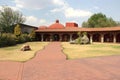 Colonnial farm and country house, stone and red brick construction with arches and green grass garden Royalty Free Stock Photo