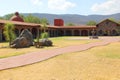 Colonnial farm and country house, stone and red brick construction with arches and green grass garden Royalty Free Stock Photo