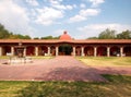 Colonnial farm and country house, stone and red brick construction with arches and green grass garden Royalty Free Stock Photo