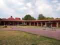 Colonnial farm and country house, stone and red brick construction with arches and green grass garden Royalty Free Stock Photo