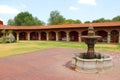 Colonnial farm and country house, stone and red brick construction with arches and green grass garden Royalty Free Stock Photo