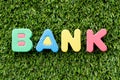 Color alphabet letter in word bank on green grass background