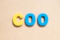 Color letter in word COO (abbreviation Chief operating officer) on wood background