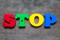 Color alphabet in word stop on wood background