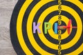 Color alphabets KPI acronym Key Performance Indicator on dartsboard background with red arrow hit center of target. Royalty Free Stock Photo