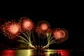 The color and beautiful of fireworks set up in the sea, in the black sky at night time Royalty Free Stock Photo