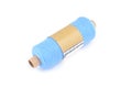 Color bobbin of yarn with label. Side view. Textile reel on isolated white background