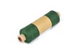 Color bobbin of yarn with label. Side view. Textile reel on isolated white background