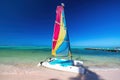 Color catamaran sailboat, windsurf, kayak, and parasailing summer water activities on tropical island beach and caribbean sea Royalty Free Stock Photo