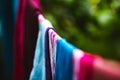 Color clothes dress hanging and drying laundry outside of the home garden with selective center focus of the frame