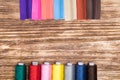 Color coils with threads and bright zippers on a wooden background Royalty Free Stock Photo