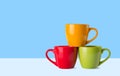 Many colorful coffee cups on blue background