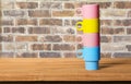 Many colorful coffee cups on table background