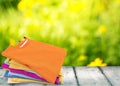 Stack of colorful t-shirts on wooden table with