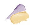 Color corrector strokes isolated on white background. Yellow and lilac color correcting cream concealer smudge