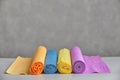 Color corrugated paper, rolled into rolls on gray background. Royalty Free Stock Photo