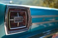 Color detail on the backlight, stop light of a vintage car sky blue color and shiny chrome, selective focus, turquoise, copy space Royalty Free Stock Photo