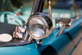Color detail on the headlight of a vintage car sky blue color and shiny chrome, selective focus, turquoise Royalty Free Stock Photo