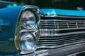 Color detail on the headlight of a vintage car sky blue color and shiny chrome, selective focus, turquoise Royalty Free Stock Photo